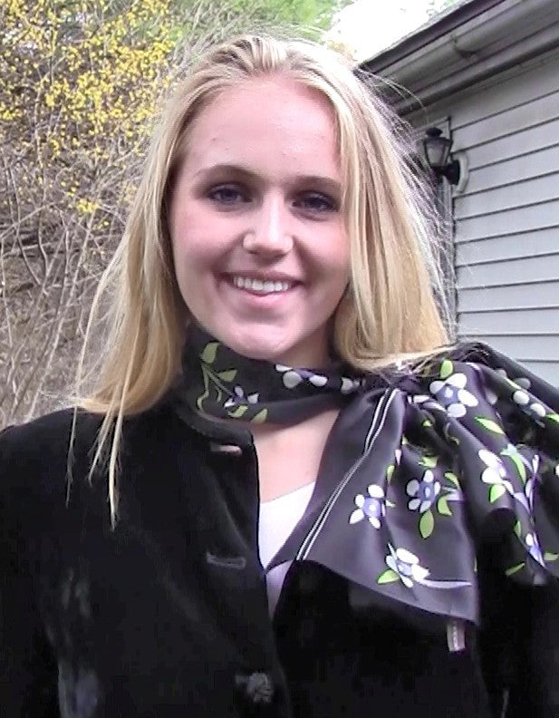 White floral silk scarf on black background worn by model for elegant evening styling