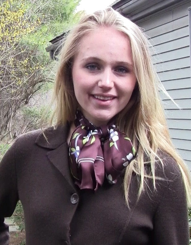 White floral silk scarf on cocoa background worn by model in natural outdoor setting