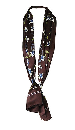 Silk scarf with white floral design on cocoa background tied in classic neck style